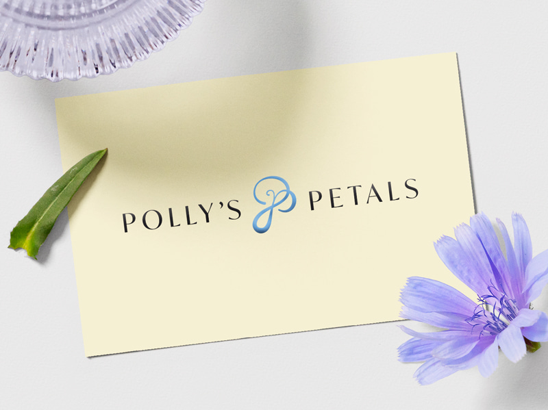 Mockup of Polly's Petals' new logo on the back of a business card.