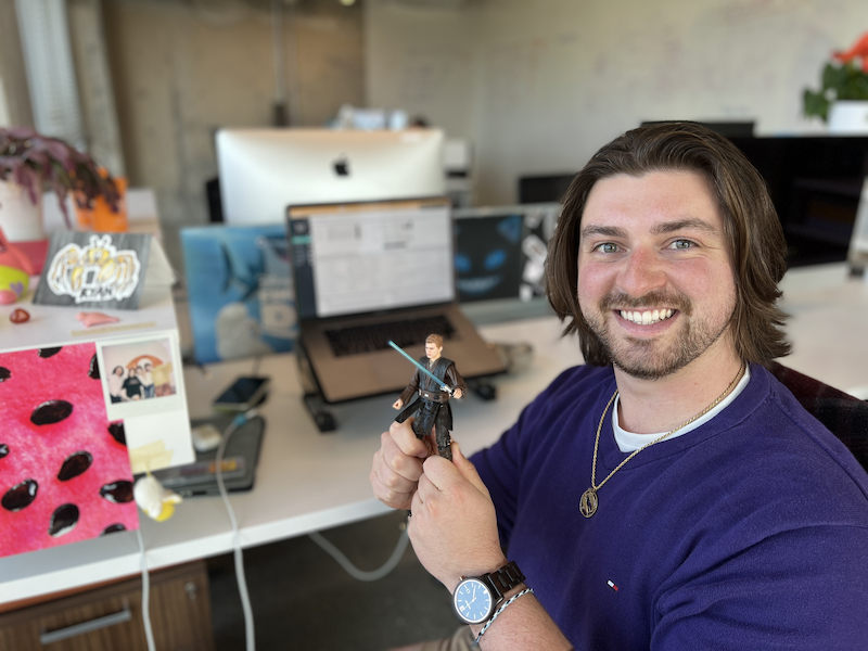 Ryan at his desk with a Star Wars figurine